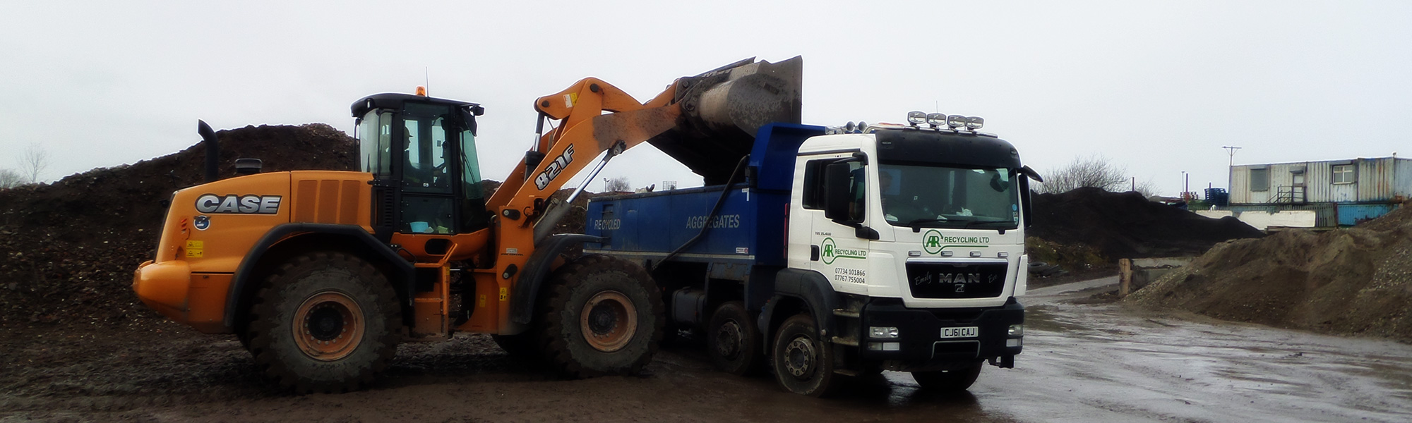 Digger loading a lorry.